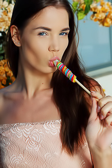Sexy brunette Lovenia Lux sucks suggestively on her candy, her beautiful blue eyes so flirtatious