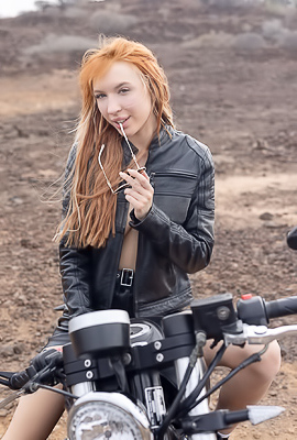 Lilly Mays Rides A Motorcycle In The Desert Wearing A Leather Jacket And Miniskirt