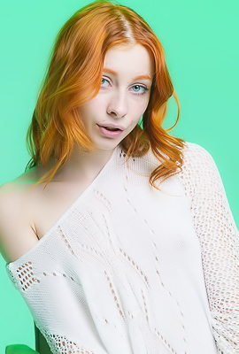 Carolina Sun Seductively Poses Nude In A White Sweater On A Green Chair With Legs Spread