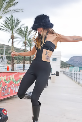 Irene Teasing Tattooed Skin Under Palm Trees, Boots Glistening on the Waterfront
